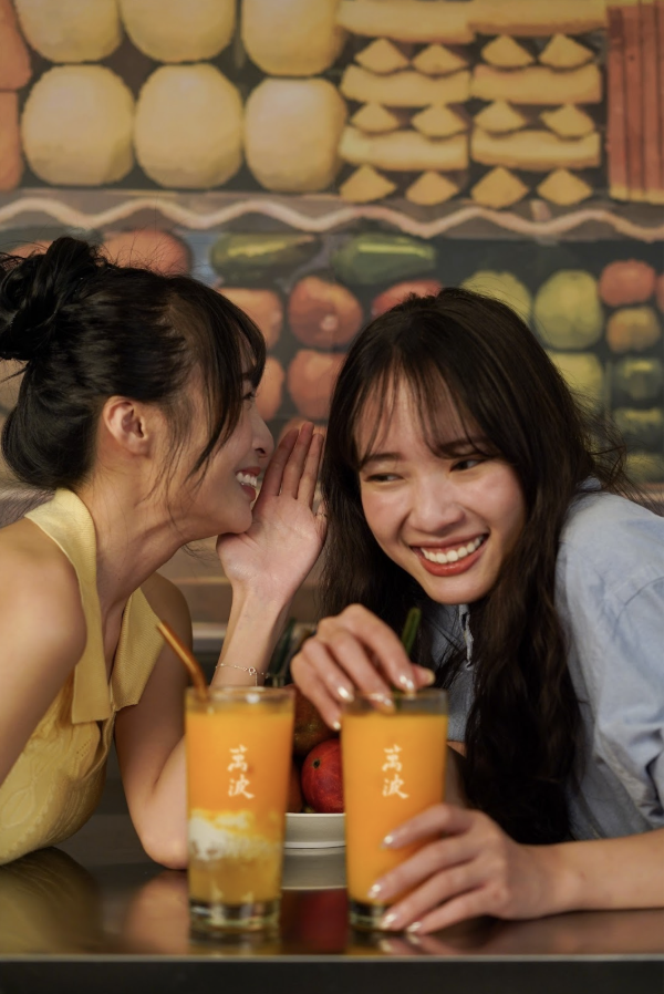 Two women talking and bonding with boba drinks